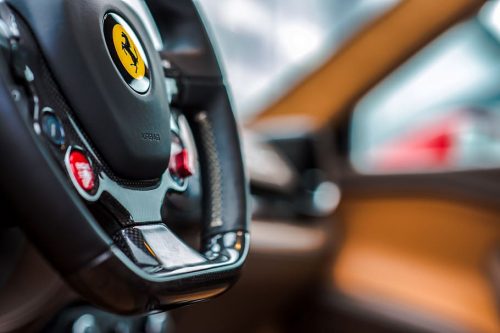 ferrari-steering-wheel-the-ferrari-logo-in-yellow-engine-start-button-background-car-flyer-luxury-car